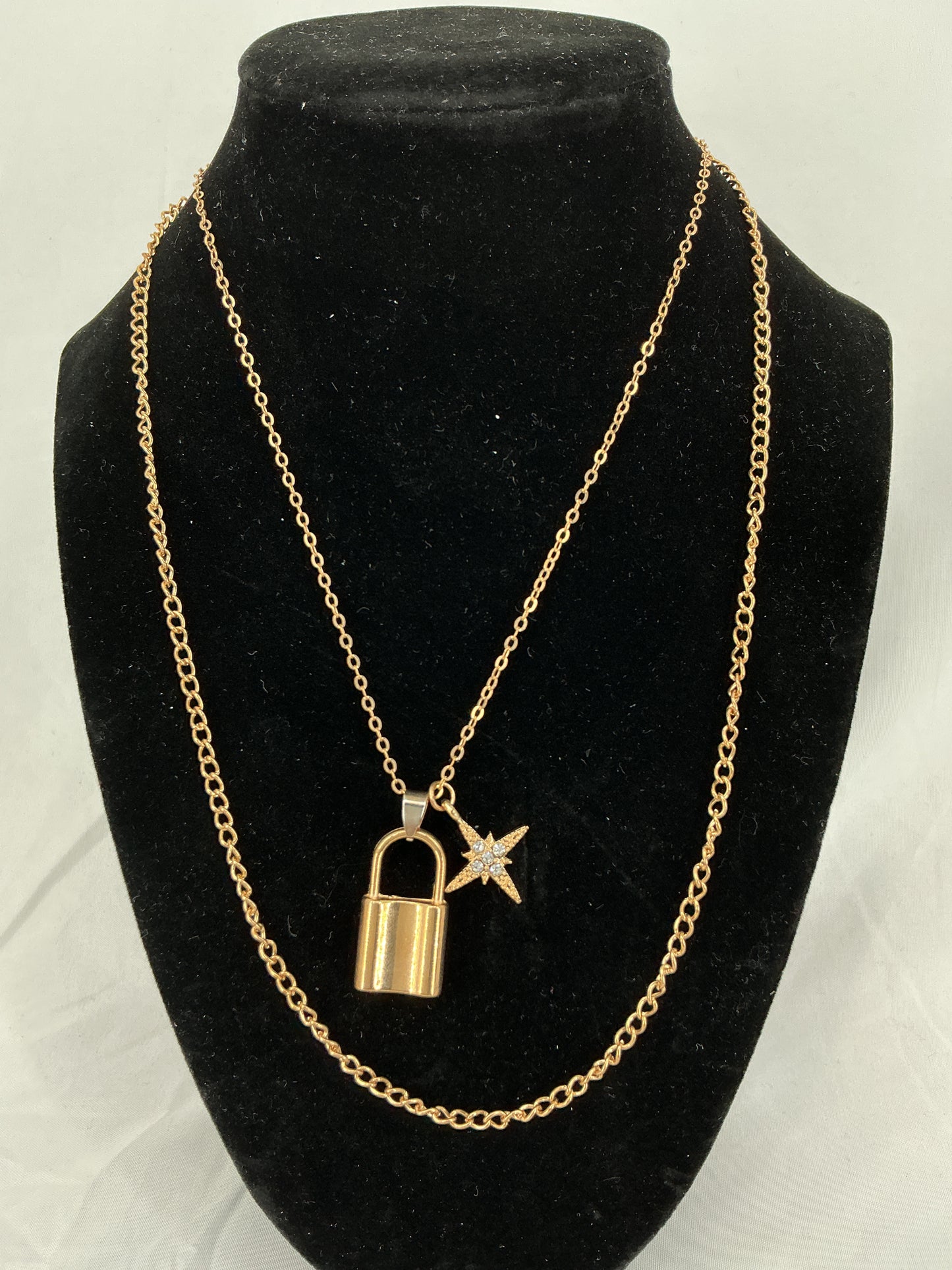 Gold padlock and North Star pendant necklace