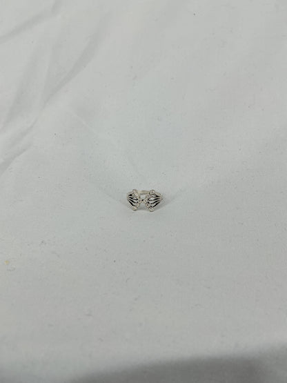 A silver ring, a crown/fan-shaped openwork design with inlaid stones.