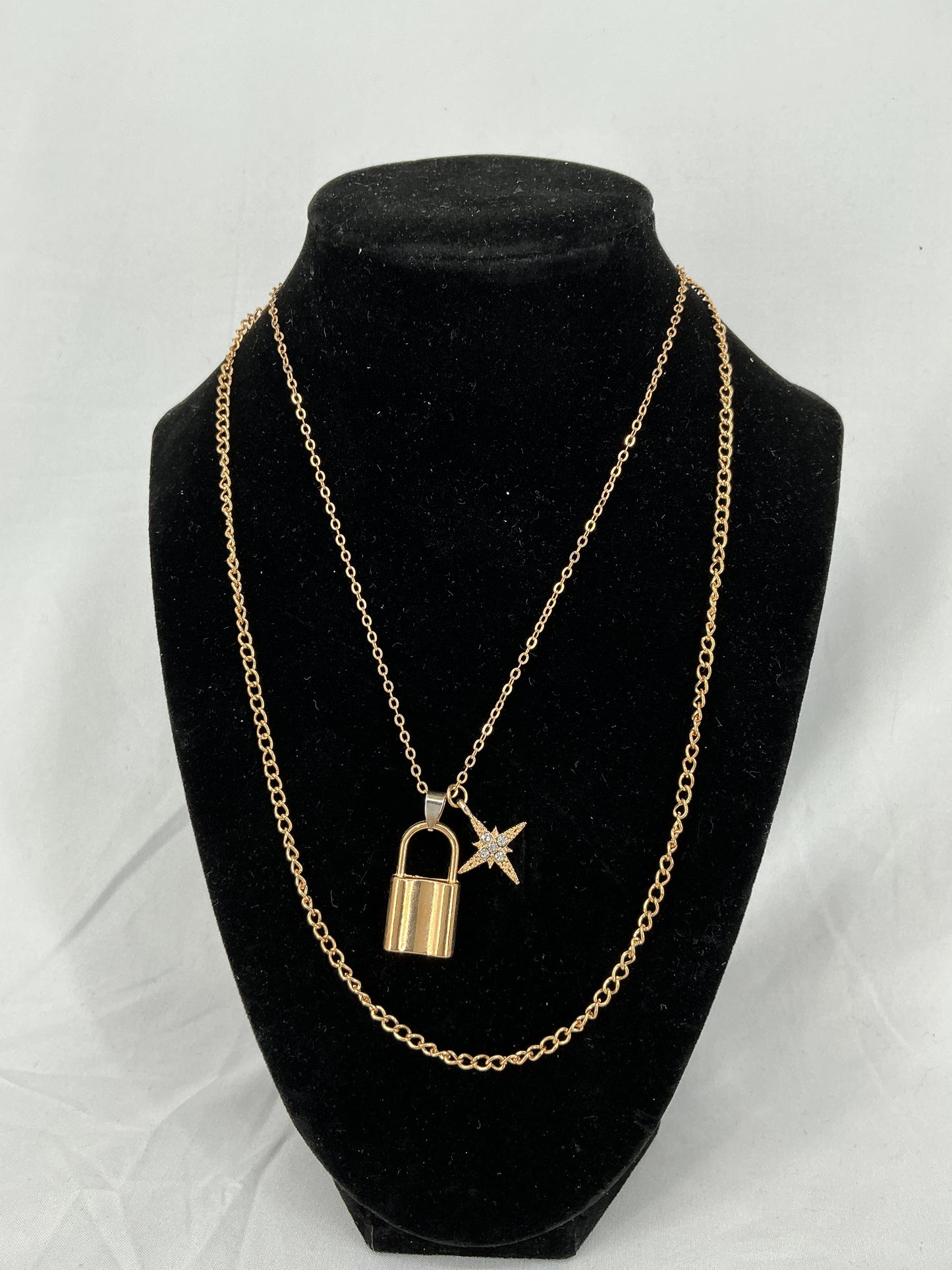 Gold padlock and North Star pendant necklace