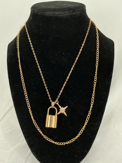 Gold padlock and North Star pendant necklace