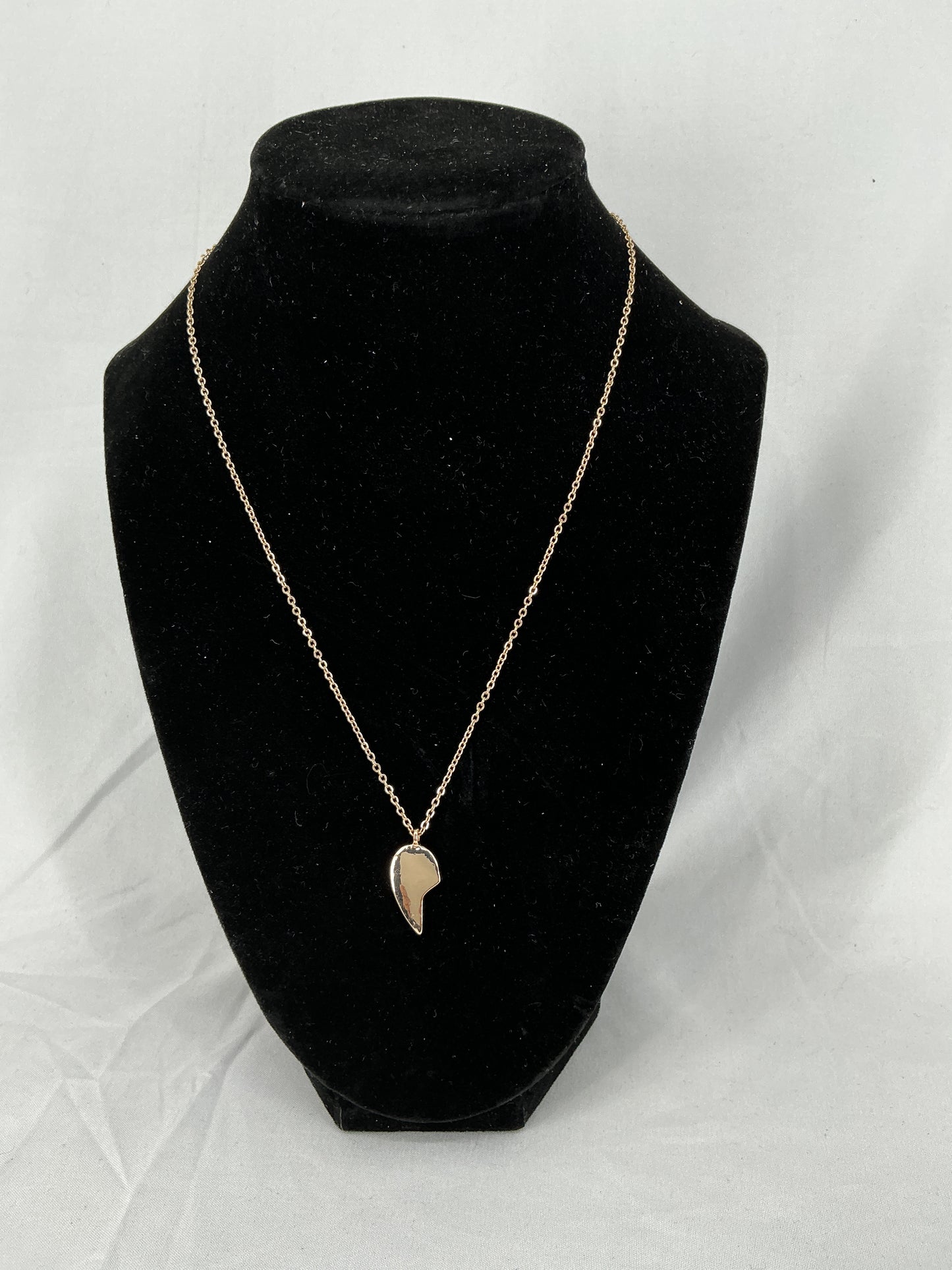 Gold half-heart pendant necklace