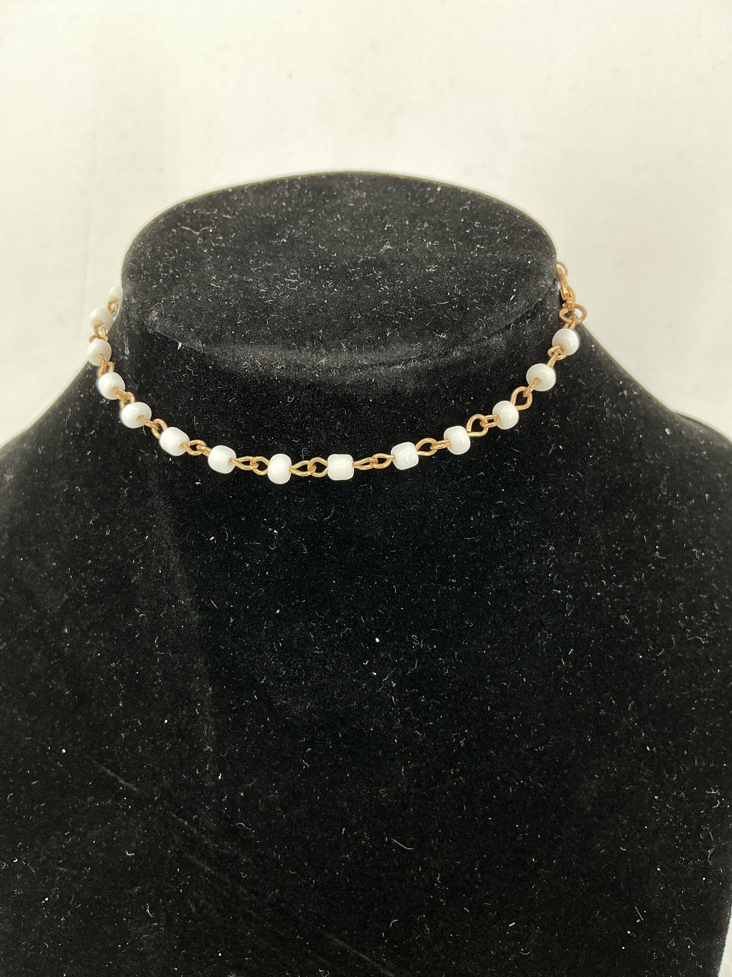 Gold chain necklace with white beads