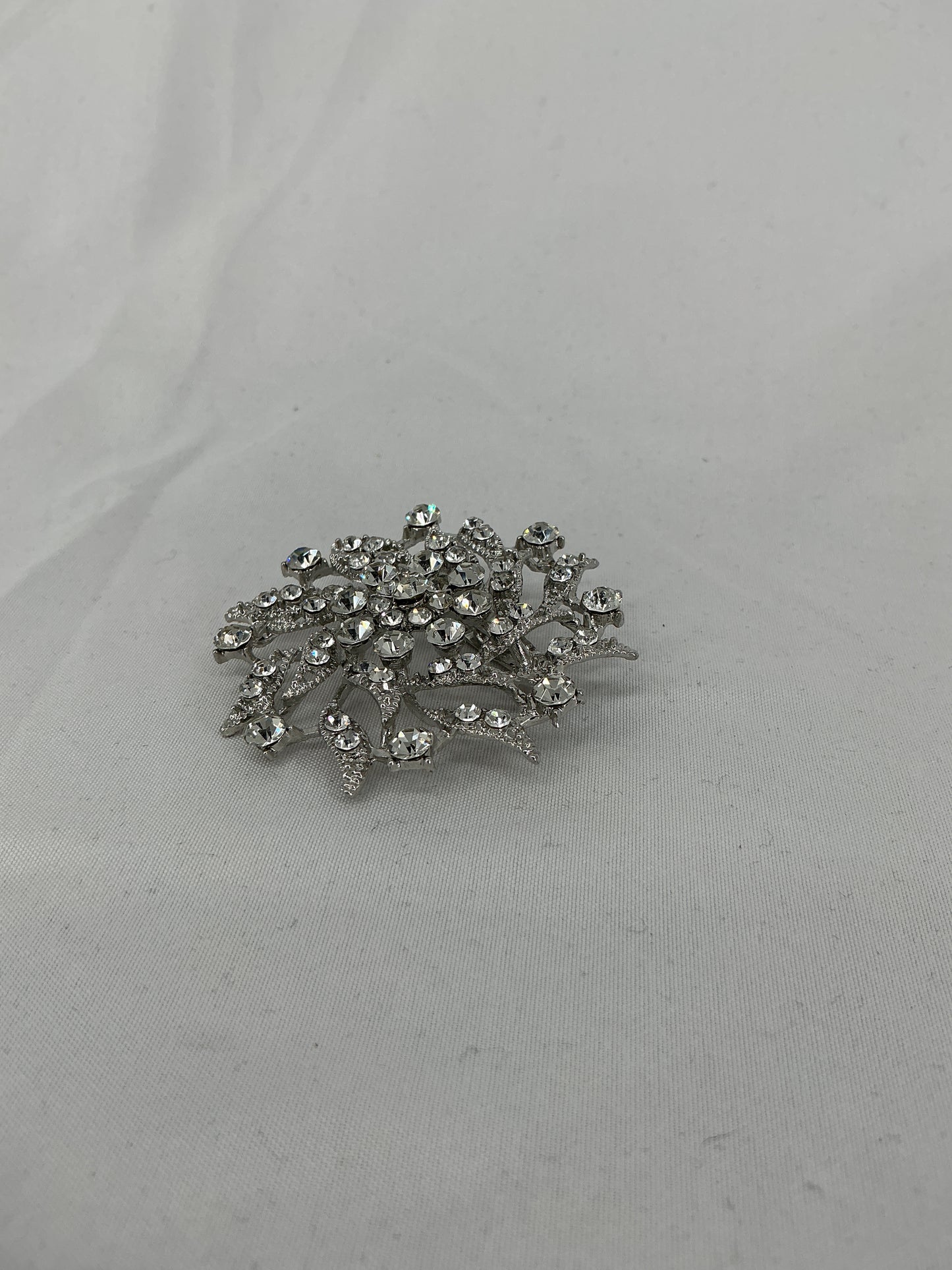 Silver radial rhinestone brooch