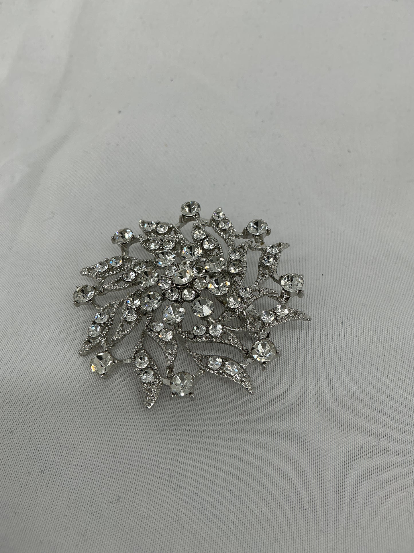 Silver radial rhinestone brooch